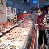 Người tiêu dùng mua thịt lợn tại siêu thị BigC (Hà Nội). (Ảnh: TTXVN)