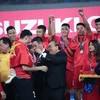 Thủ tướng Nguyễn Xuân Phúc trao huy chương vô địch AFF Suzuki Cup 2018 cho thủ môn Đặng Văn Lâm và các cầu thủ đội tuyển Việt Nam. (Ảnh: Trọng Đạt/TTXVN)