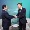 Thủ tướng Phạm Minh Chính gặp Tổng thống Pháp Emmanuel Macron. (Ảnh: Dương Giang/TTXVN)