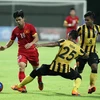 Các cầu thủ U23 Malaysia (áo vàng) đã thua tan 5-1 trước Việt Nam. (Ảnh: TTXVN)