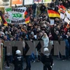 Biểu tình phản đối chính sách về người nhập cư và bạo lực với phụ nữ tại nhà ga Koln, thành phố Cologne, Đức ngày 9/1. (Nguồn: AFP/TTXVN)