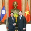 Chủ tịch nước Trần Đại Quang tiếp Thủ tướng Lào. (Ảnh: Nhan Sáng/TTXVN)