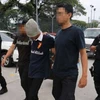 Một đối tượng bị cảnh sát Malaysia bắt giữ. (Nguồn: straitstimes.com)