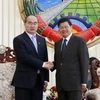 Thủ tướng Thongloun Sisoulith tiếp đồng chí Nguyễn Thiện Nhân cùng đoàn. (Ảnh: Phạm Kiên/Vietnam+)