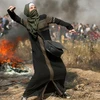 Một phụ nữ người Palestine chống trả quân đội Israel. (Nguồn: Reuters)
