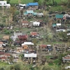 Nhiều ngôi nhà bị tàn phá do bão Mangkhut tại tỉnh Cagayan, miền bắc Philippines ngày 16/9. (Ảnh: AFP/TTXVN)