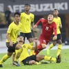 Quang Hải (áo đỏ) chính là cầu thủ xuất sắc nhất AFF Suzuki Cup 2018. (Ảnh: Hoàng Linh/TTXVN)