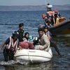 Lực lượng cứu hộ trợ giúp người di cư từ Thổ Nhĩ Kỳ tới Hy Lạp. (Ảnh: AFP/TTXVN)