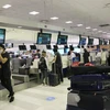 Công dân làm thủ tục tại sân bay quốc tế Sydney. (Ảnh: TTXVN)