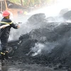 Dập tắt đám cháy tại khóm Mỹ Thọ, phường Mỹ Quý, thành phố Long Xuyên, tỉnh An Giang chiều 14/2. (Ảnh: TTXVN)