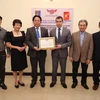 Đại diện Hội hữu nghị Việt Nam-Azerbaijan trao tượng trưng khẩu trang y tế cho Đại sứ Azerbaijan tại Việt Nam. (Ảnh: Nguyễn Cúc/TTXVN)