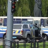 Cảnh sát nỗ lực tiếp cận đối tượng có vũ trang đang bắt giữ khoảng 20 người trên chiếc xe khách làm con tin tại thành phố Lutsk, Tây Bắc Ukraine ngày 21/7/2020. (Ảnh: Reuters/TTXVN)