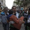 Nhân viên cứu hộ chuyển người bị thương trong vụ oanh tạc của Israel xuống thành phố Khan Younis, phía Nam Dải Gaza ngày 1/12/2023. (Ảnh: THX/TTXVN)