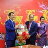 Tỉnh trưởng Oum Reatrey tặng quà Tết Chủ tịch Ủy ban Nhân dân tỉnh Vĩnh Long Lữ Quang Ngời (trái). (Ảnh: Phạm Minh Tuấn/TTXVN)