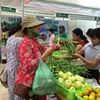 Người tiêu dùng mua rau quả tại phiên chợ nông sản. (Ảnh: Thanh Tâm/Vietnam+)