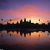 Hình ảnh soi bóng xuống nước kỳ ảo của đền thờ Angkor Wat, Campuchia dưới ánh hoàng hôn. (Nguồn: Getty Images)