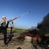 Người biểu tình bạo động Palestine gần Shejaiya, thành phố Gaza ngày 18/12/2015. (Nguồn: AFP/TTXVN)