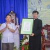 Lãnh đạo Sở Nội vụ tỉnh Điện Biên trao Quyết định thành lập Giáo xứ cho Giáo phận Hưng Hóa. (Ảnh: Xuân Tư/TTXVN)