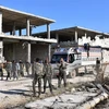 Lực lượng ủng hộ Chính phủ Syria sau khi giành lại quyền kiểm soát quận Myessar, phía Đông Aleppo ngày 4/12. (Nguồn: AFP/TTXVN)