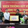 Phó Chủ tịch Ủy ban Nhân dân thành phố Hồ Kỳ Minh (áo trắng) trao thưởng nóng cho cán bộ, chiến sỹ lực lượng phòng chống tội phạm ma túy Bộ đội biên phòng Đà Nẵng. (Ảnh: Trần Lê Lâm/Vietnam+)