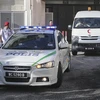 Xe cảnh sát và xe cứu thương mang thi thể ông Kim Jong-nam rời bệnh viện ở Putrajaya, Malaysia ngày 15/2. EPA/TTXVN