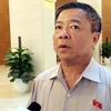 Ông Võ Kim Cự trong lần trả lời báo chí tại hành lang kỳ họp thứ 1, Quốc hội khóa XIV. (Ảnh: P.T/Vietnam+)
