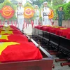 Truy điệu và an táng hài cốt liệt sỹ Việt Nam hy sinh tại Lào. (Ảnh: Quốc Việt/TTXVN)