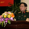 Đại tướng Ngô Xuân Lịch, Ủy viên Bộ Chính trị, Phó Bí thư Quân ủy Trung ương, Bộ trưởng Bộ Quốc phòng chủ trì Hội thảo. (Nguồn: TTXVN)