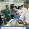 Phó Thủ tướng Vũ Đức Đam thăm các phòng điều trị bệnh nhân sốt xuất huyết tại bệnh viện Bệnh Nhiệt đới Trung ương. (Ảnh: Dương Ngọc/TTXVN)