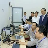Chủ tịch nước Trần Đại Quang với cán bộ, phóng viên, biên tập viên TTXVN. (Ảnh: Nhan Sáng/TTXVN)