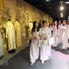 Các em học sinh xem các mẫu áo dài tại triển lãm 'Duyên dáng Áo dài Thành phố Hồ Chí Minh.' (Ảnh: Quang Nhựt/TTXVN)