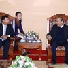 Thủ tướng Nguyễn Xuân Phúc tiếp Thống đốc Ngân hàng Cộng hòa Dân chủ Nhân dân Lào Sonexay Sitphayxay. (Ảnh: Thống Nhất/TTXVN)