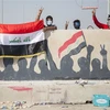 Người biểu tình Iraq phong tỏa tuyến đường cao tốc dẫn đến cảng Umm Qasr, miền nam Iraq ngày 3/11/2019. (Ảnh: AFP/TTXVN)