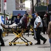 Lực lượng phản ứng nhanh chuyển một người nghi nhiễm COVID lên xe cứu thương ở khu Brooklyn, New York, Mỹ ngày 8/5/2020. (Ảnh: THX/TTXVN)