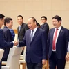 Thủ tướng Nguyễn Xuân Phúc với lãnh đạo các doanh nghiệp tiêu biểu. (Ảnh: Thống Nhất/TTXVN)