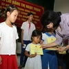 Phó Chủ tịch nước Đặng Thị Ngọc Thịnh tặng quà cho con gia đình chính sách tại huyện Cam Lộ. (Ảnh: Hồ Cầu/TTXVN)