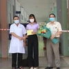 Đại diện Bệnh viện Lao và bệnh Phổi tỉnh Đắk Lắk trao Giấy xuất viện cho bệnh nhân 448. (Ảnh: Tuấn Anh/TTXVN)