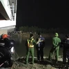 Lực lượng chức năng tìm kiếm nam học sinh bị rơi xuống sông. (Nguồn: Lao Động)