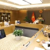 Quang cảnh cuộc họp trực tuyến từ điểm cầu Trụ sở Chính phủ với tỉnh Bắc Ninh và Bắc Giang. (Ảnh: Nguyễn Điệp/TTXVN)