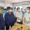 Bộ trưởng Bộ Y tế nghe báo cáo công tác thu dung, điều trị của Bệnh viện Hữu nghị Việt Đức tại Bệnh viện Dã chiến số 13. (Ảnh: TTXVN phát)
