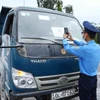 Lực lượng chức năng quét mã QR của phương tiện tham gia giao thông tại chốt kiểm soát dịch ngã 3 Cầu Giẽ, huyện Phú Xuyên hướng từ Hà Nam về Hà Nội trên tuyến Quốc lộ 1A. (Ảnh: Phạm Kiên/TTXVN)