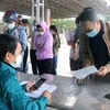 Người dân khai báo y tế tại chốt kiểm soát liên ngành phòng, chống dịch COVID-19 Dốc Xây, thị xã Bỉm Sơn, Thanh Hóa. (Ảnh: Nguyễn Nam/TTXVN)