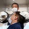 Nhân viên y tế lấy mẫu xét nghiệm COVID-19 tại Yokosuka, Kanagawa, Nhật Bản. (Ảnh: AFP/TTXVN)