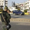 Lực lượng an ninh Chính phủ Syria gác tại một trạm kiểm soát ở Homs. (Nguồn: AFP/TTXVN)