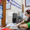 Người dân Hà Nội được giải quyết các thủ tục giấy tờ một cách nhanh chóng, rút gọn thời gian so với trước. (Nguồn: Vietnam+)