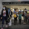 Hành khách sau khi nhập cảnh tại sân bay ở bang Texas, Mỹ. (Ảnh: AFP/TTXVN)