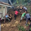Nhân viên cứu hộ tìm kiếm người mắc kẹt sau trận động đất ở Philippines. (Ảnh: AFP/TTXVN)