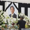 Một người đàn ông Nhật Bản bày tỏ lòng thành kính trước di ảnh của cố Thủ tướng Abe. (Ảnh: Đào Thanh Tùng/TTXVN)