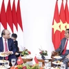 Chủ tịch nước Nguyễn Xuân Phúc gặp hẹp Tổng thống Indonesia Joko Widodo. (Ảnh: Thống Nhất/TTXVN)