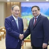 Thủ tướng Phạm Minh Chính tiếp nguyên Thủ tướng Nhật Bản Suga Yoshihide. (Ảnh: Dương Giang/TTXVN)